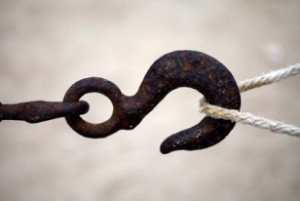 Color shot of a rusty hook and a rope